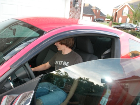 Andrew sitting in his new car